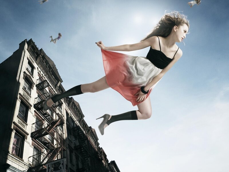 woman floating above city
