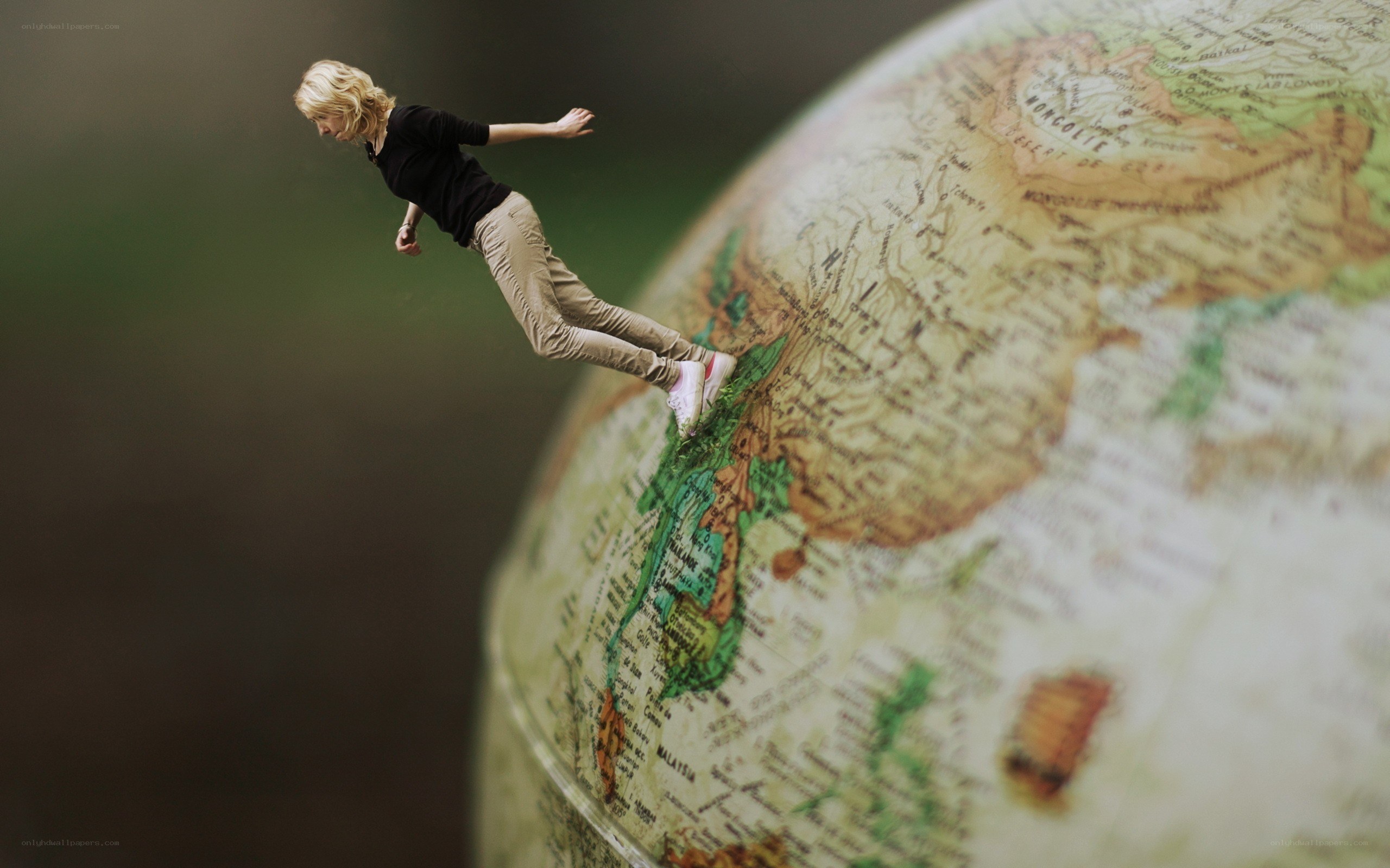 woman floating above globe