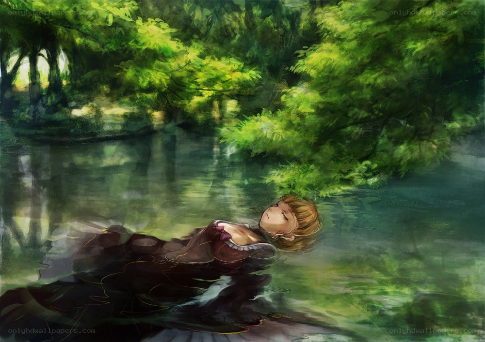 Woman floating in a forest pond