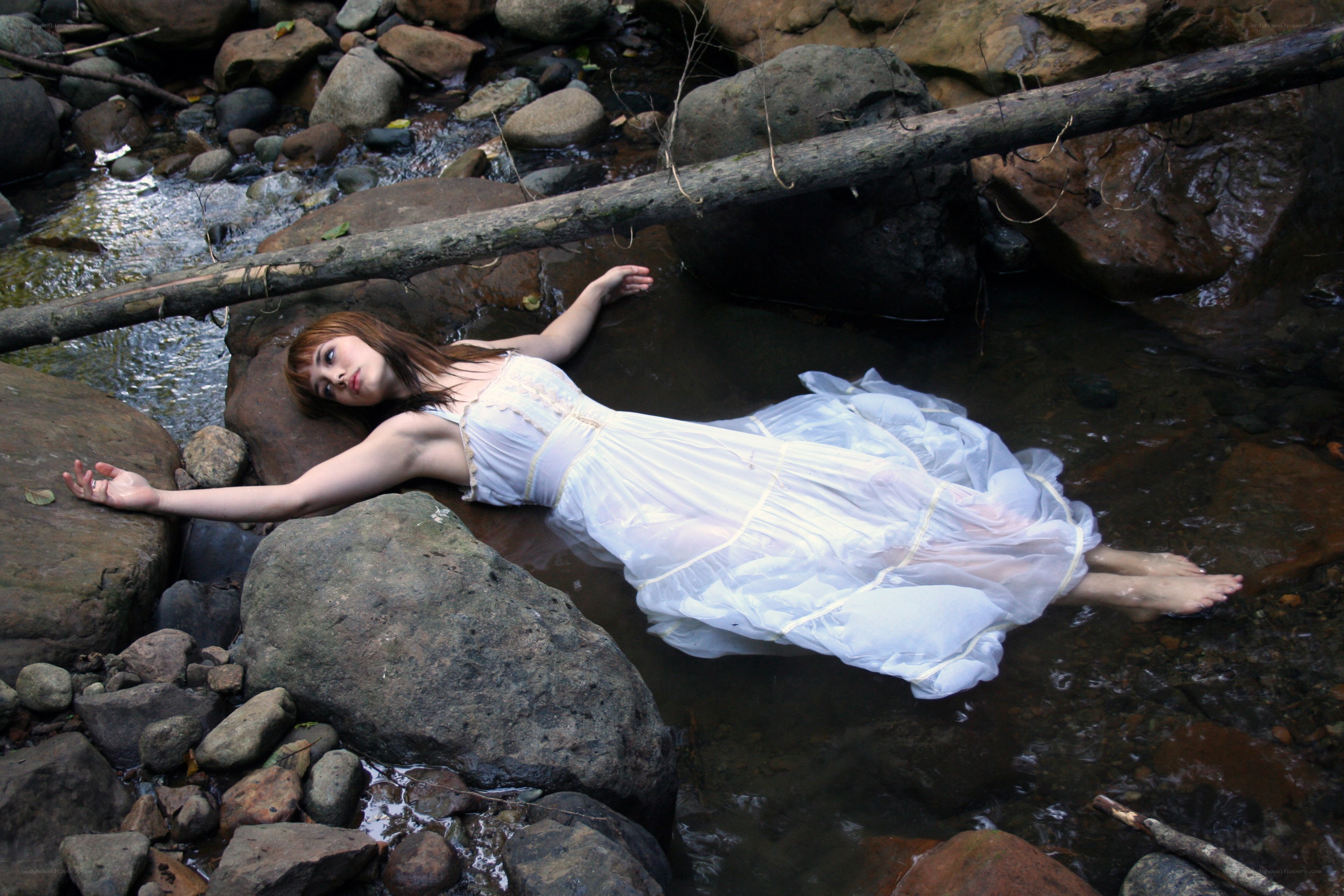 Woman floating in a stream