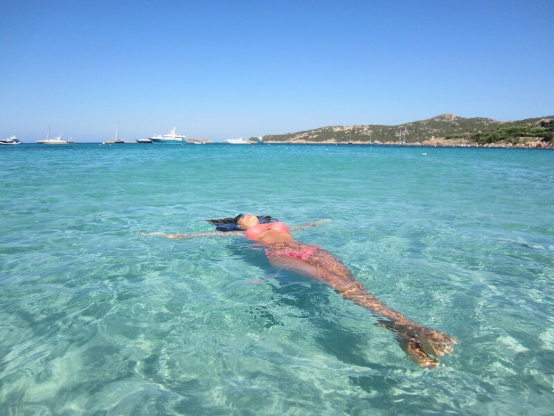 Woman floating in clear sea