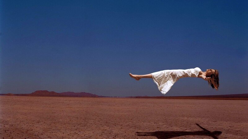 woman floating in desert