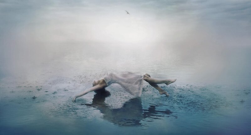 woman floating in misty water