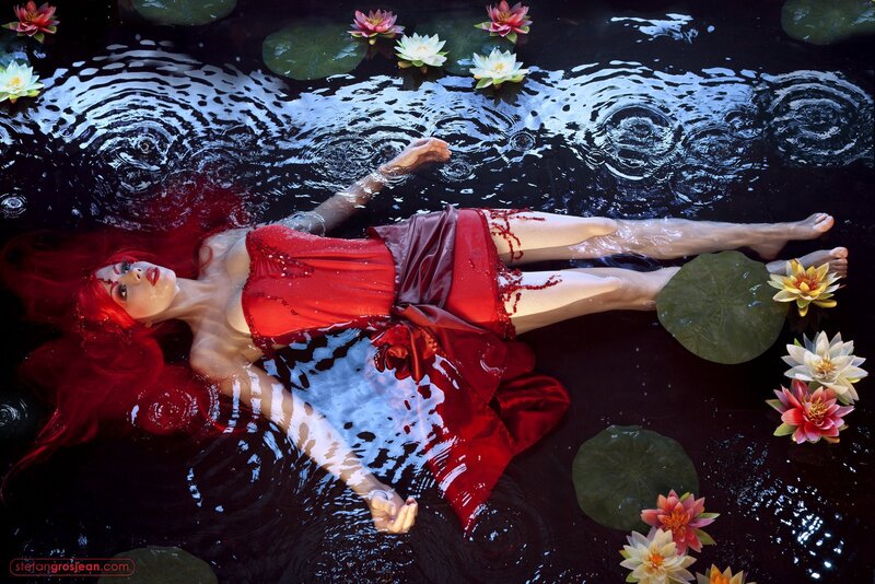 woman floating in pond with lilies