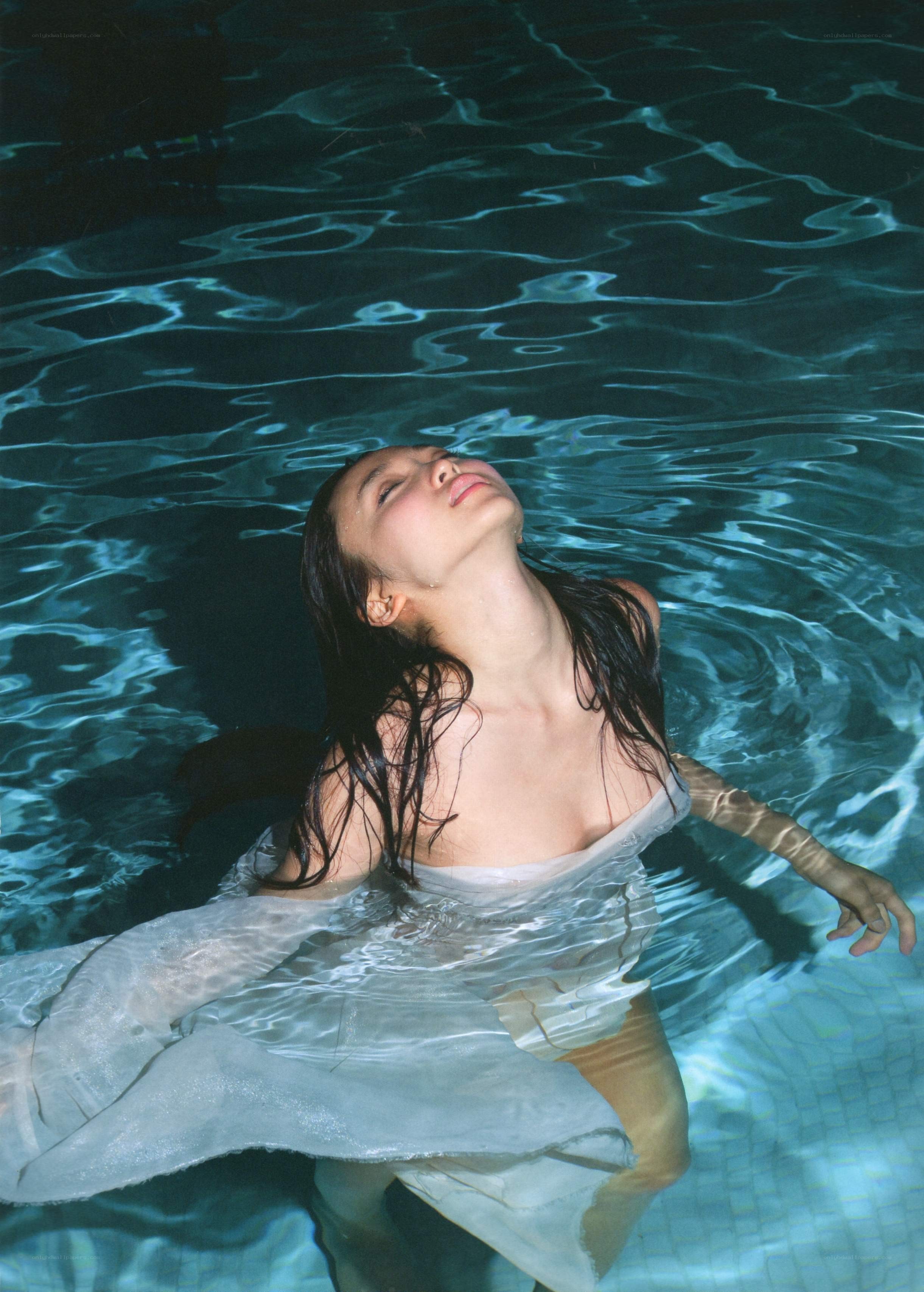 woman floating in pool