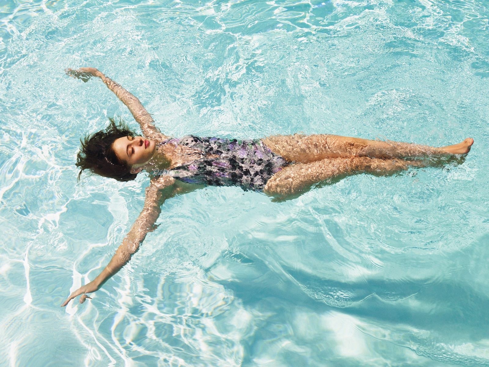woman floating in pool