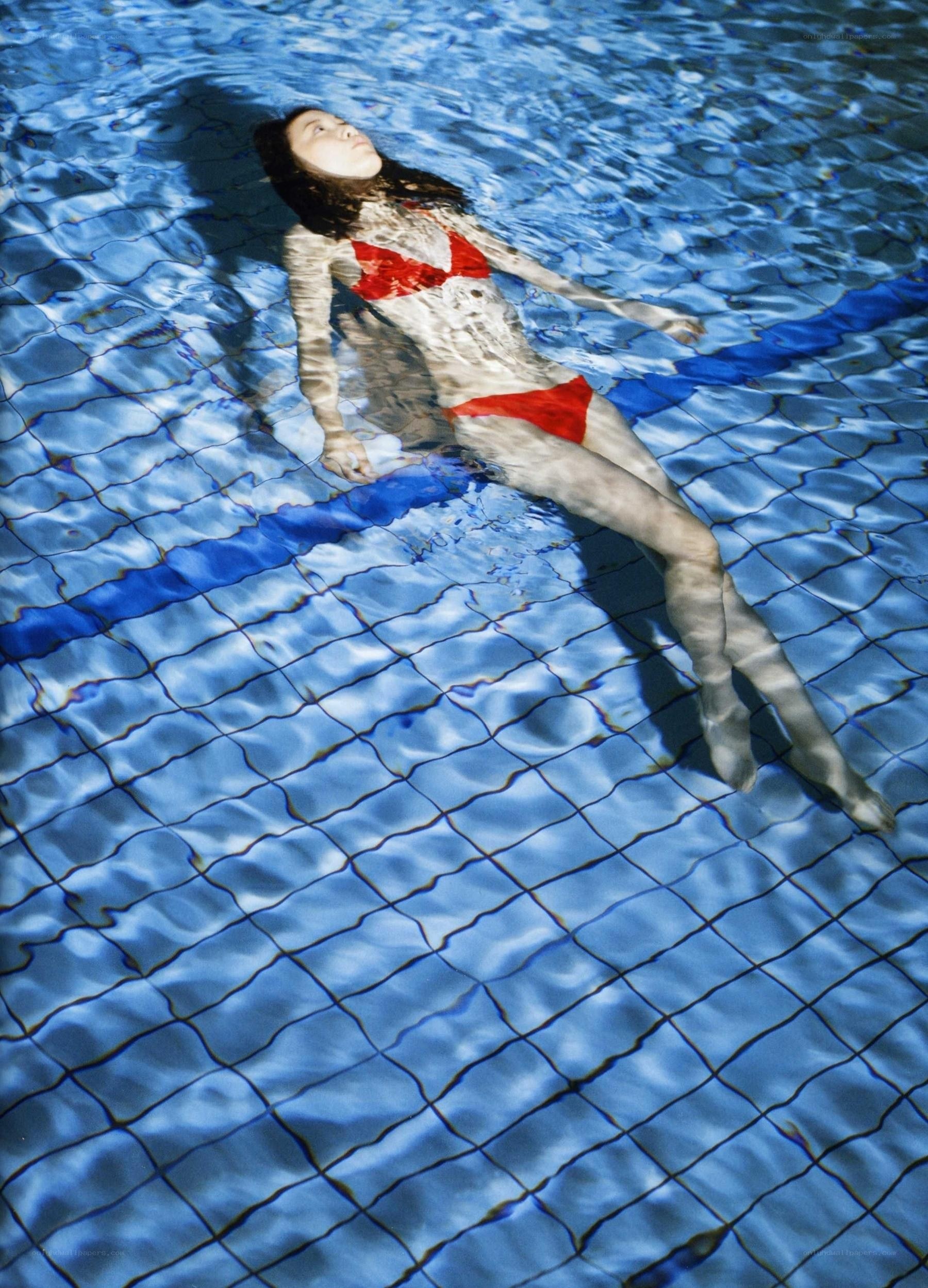 woman floating in pool