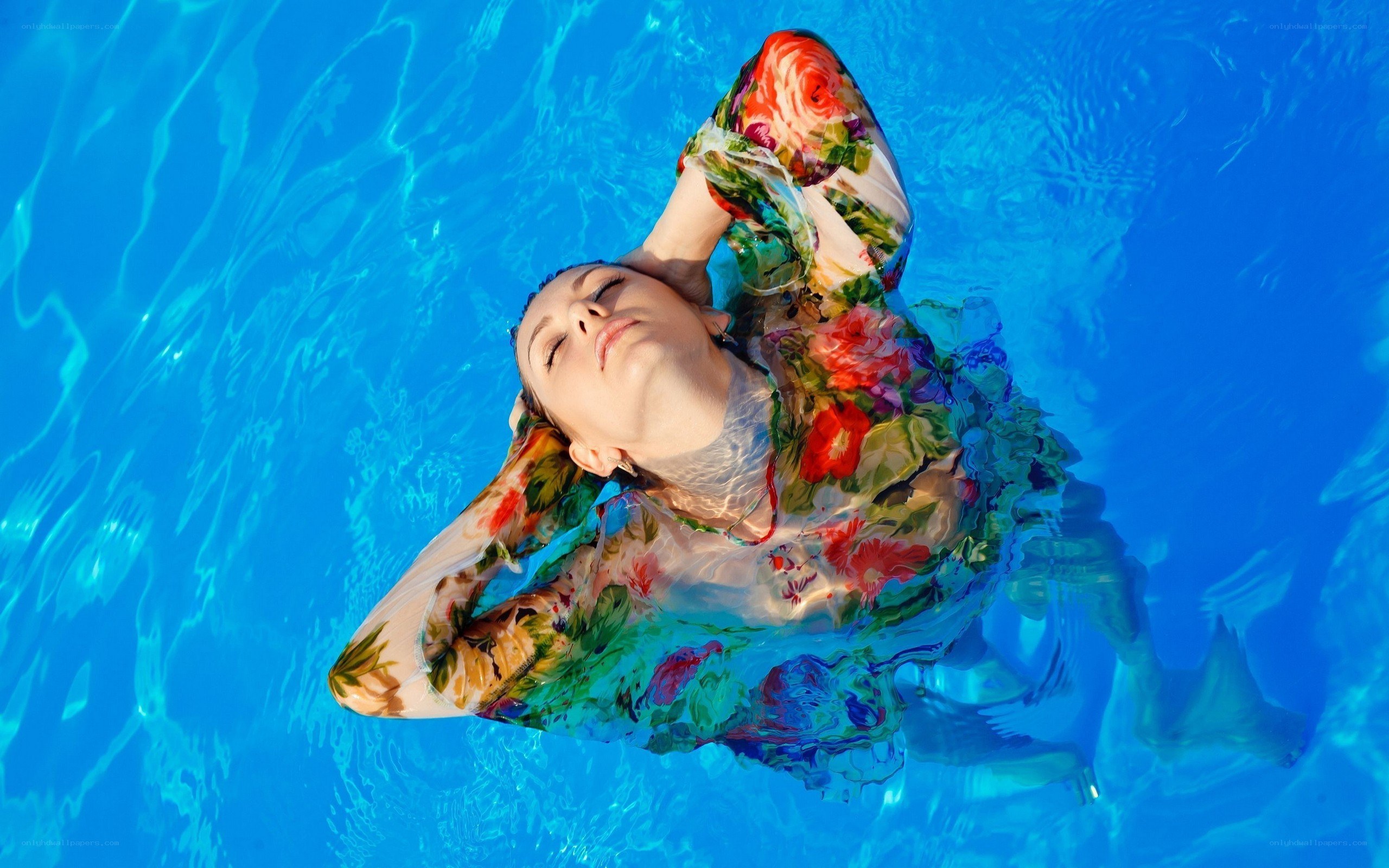 woman floating in pool