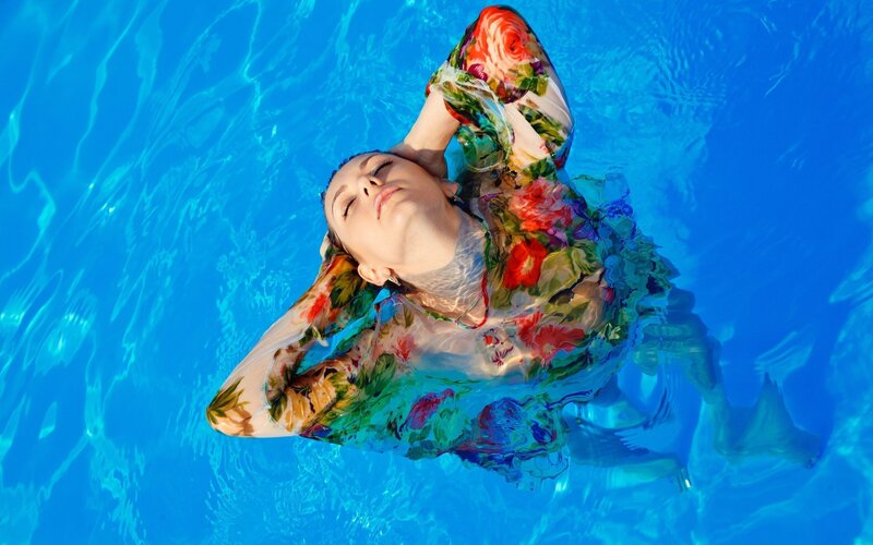 woman floating in pool