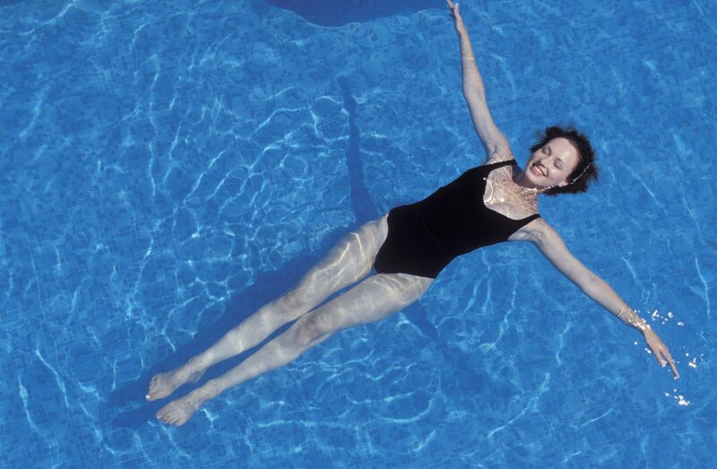 woman floating in pool