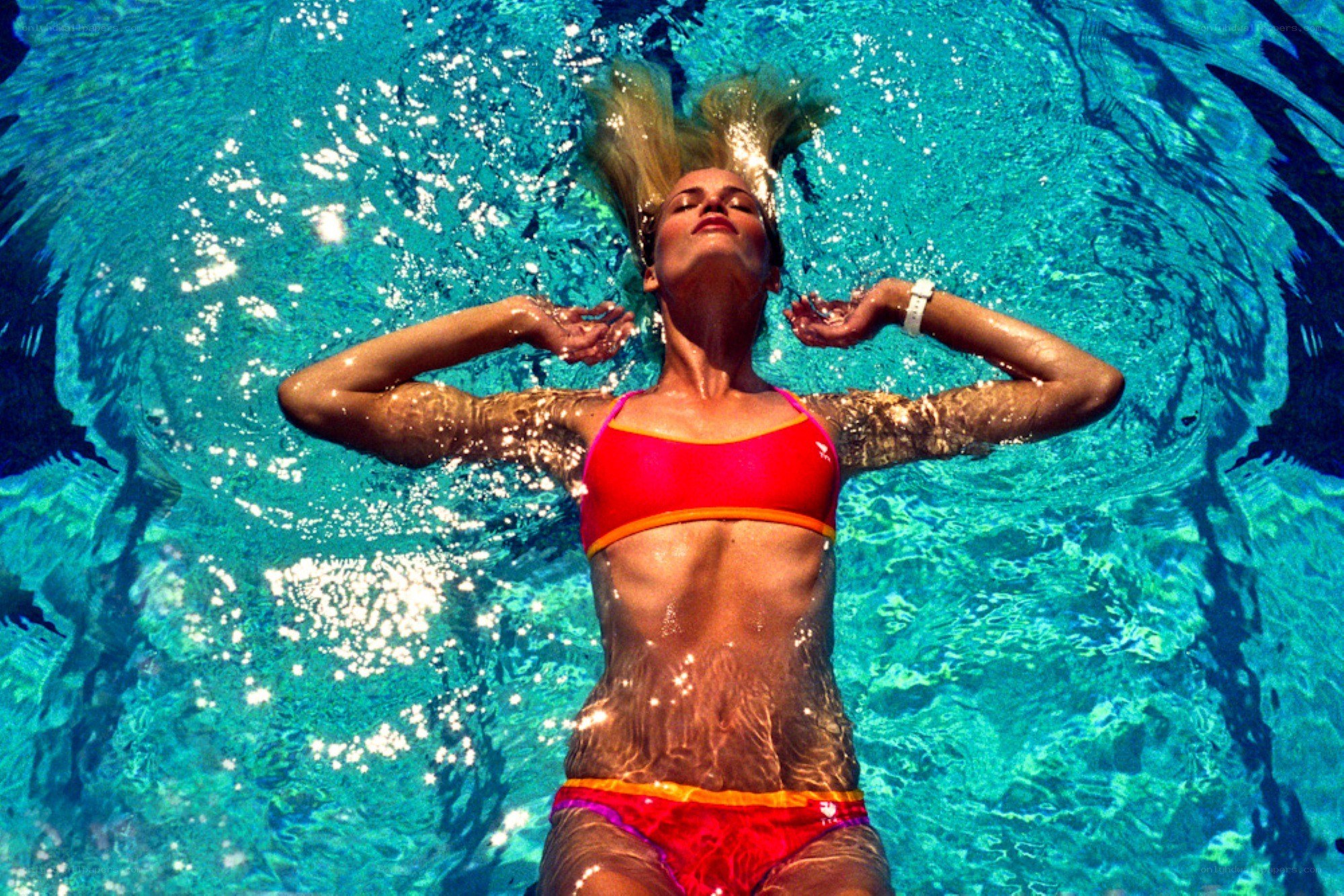 woman floating in pool