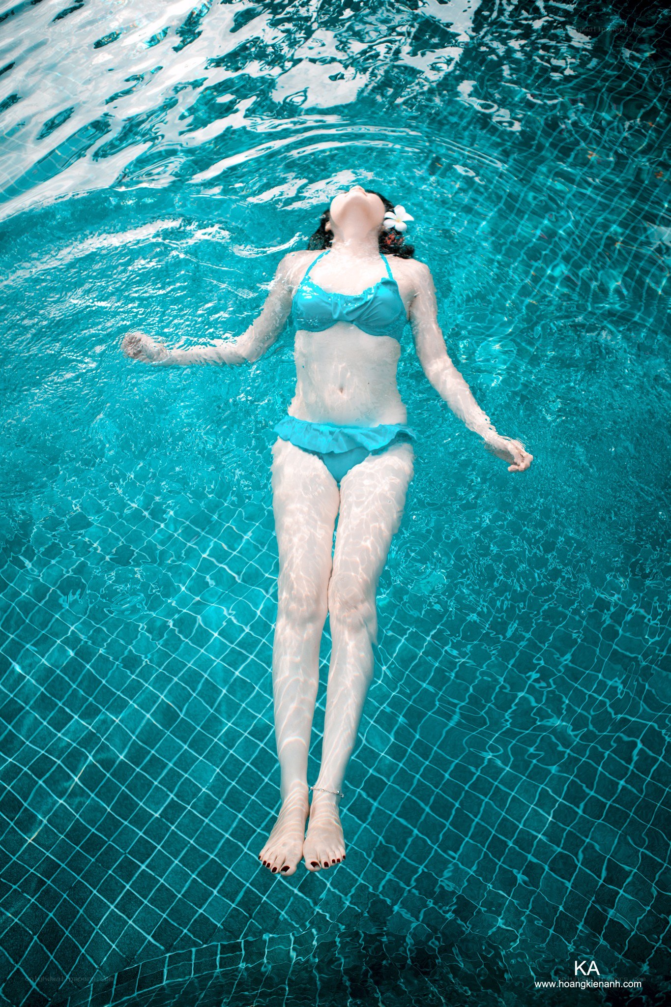 woman floating in pool