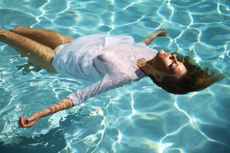 Woman floating in pool
