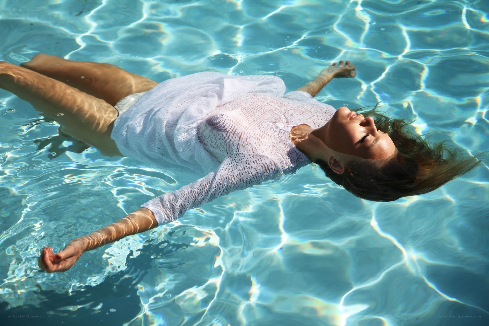 Woman floating in pool