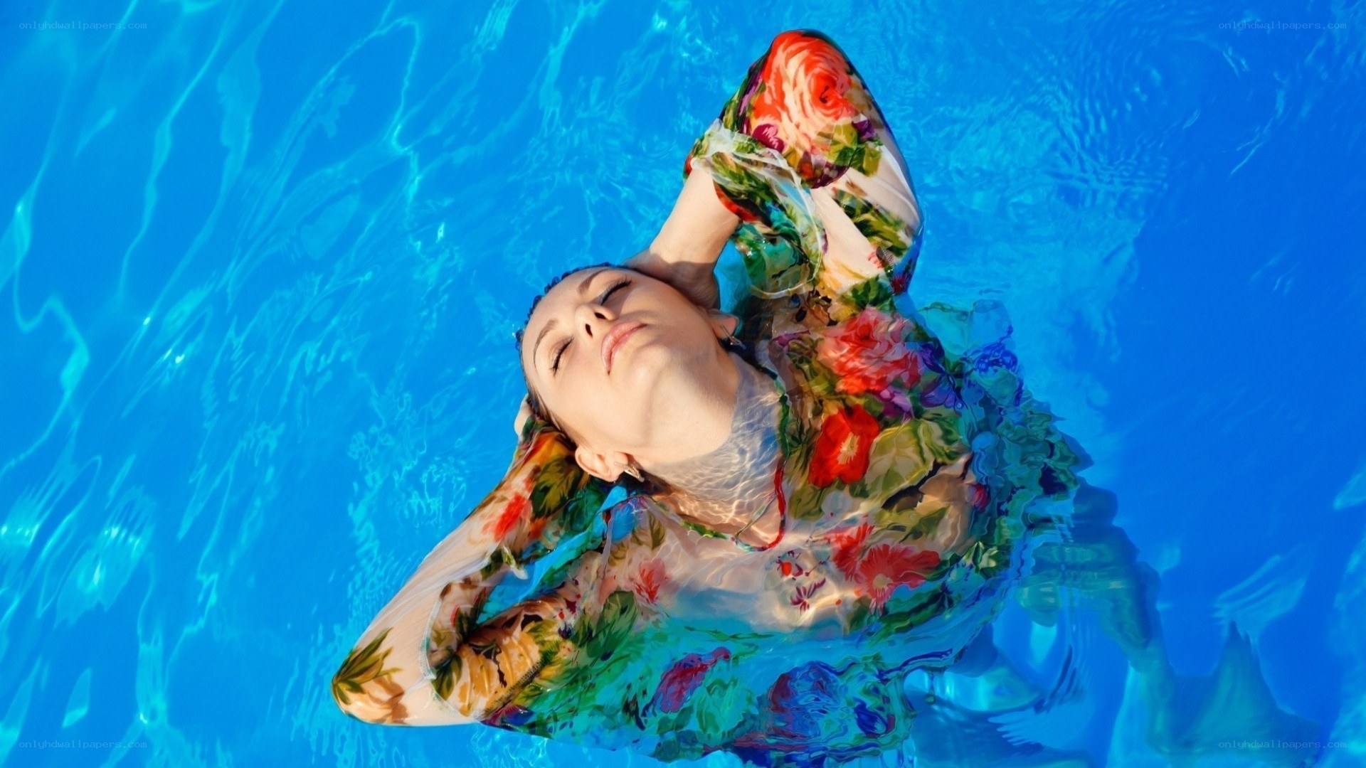 woman floating in pool