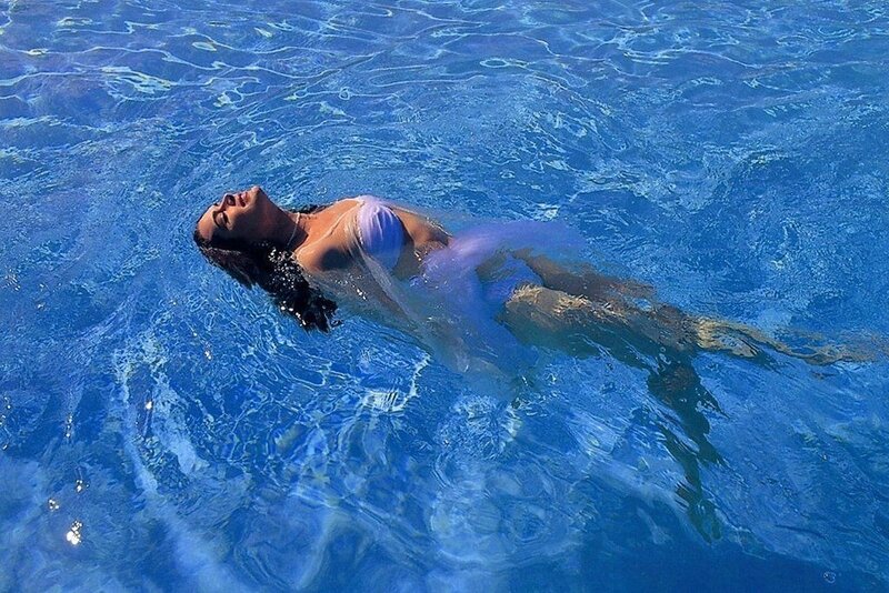 woman floating in pool