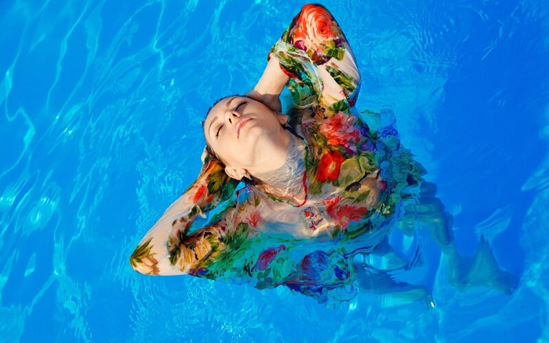 woman floating in pool
