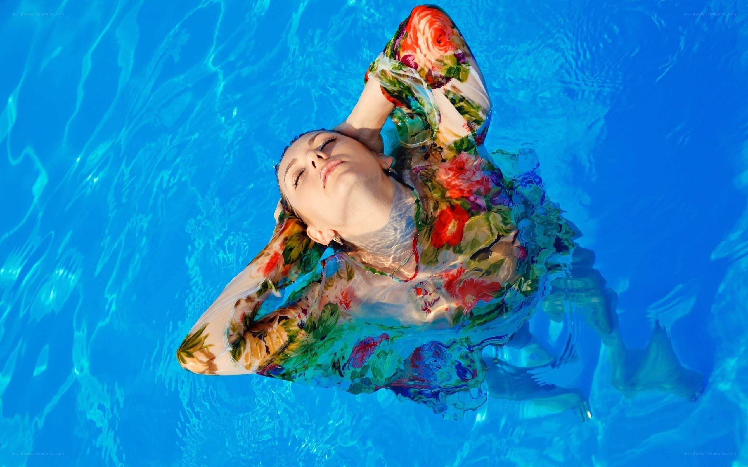 woman floating in pool