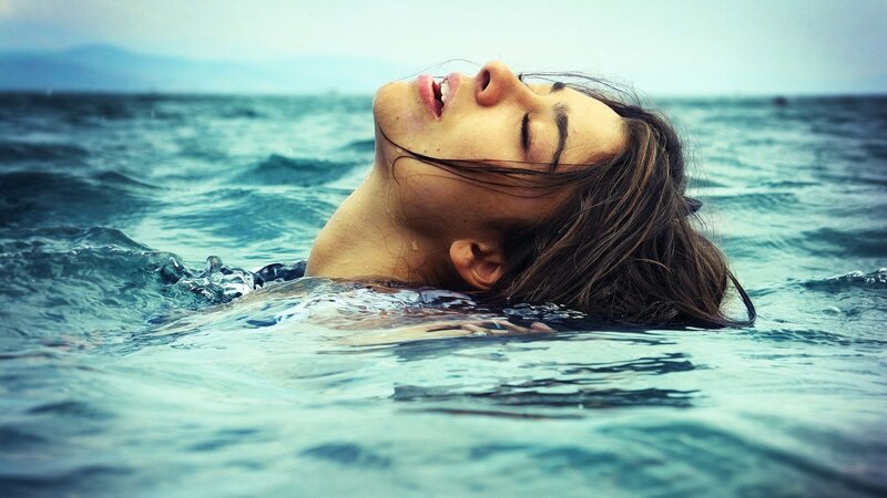 woman floating in the ocean