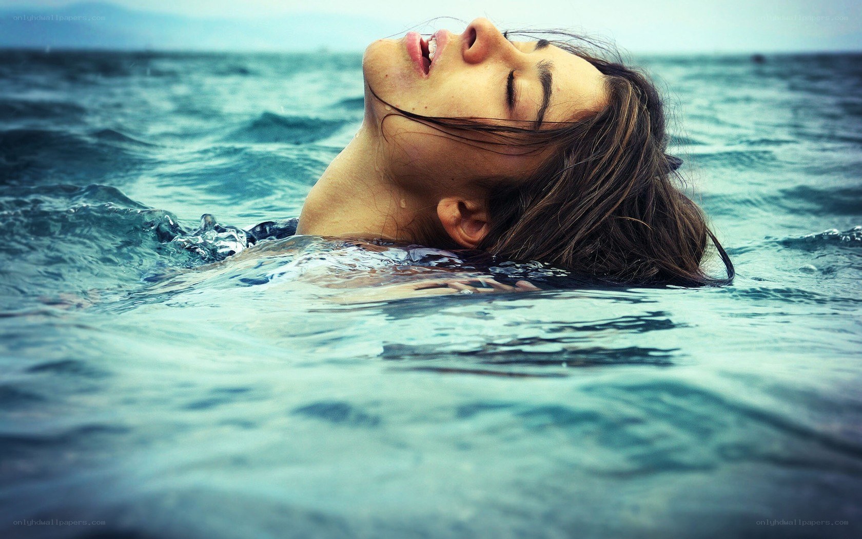 woman floating in the ocean