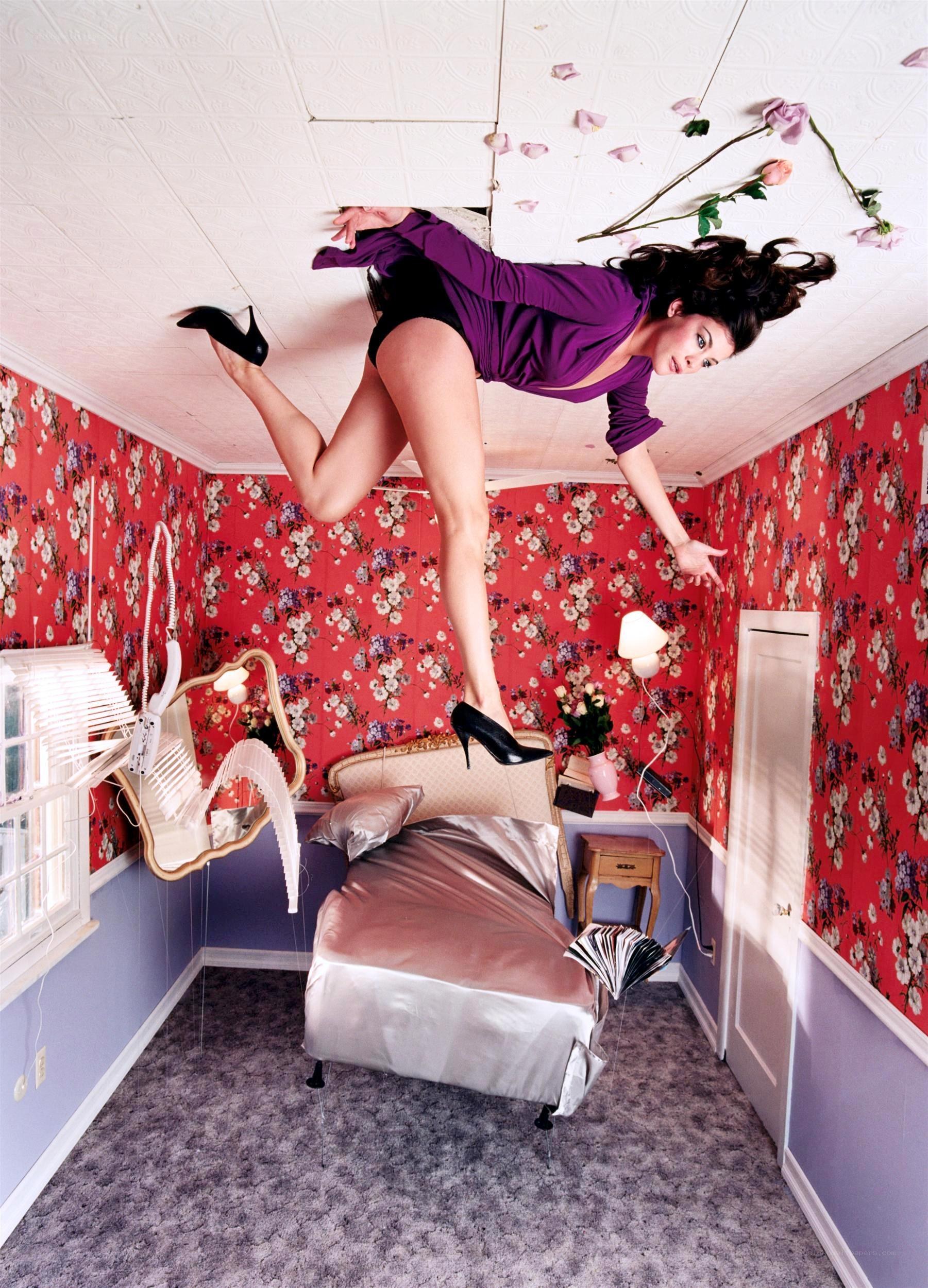 woman floating in upside-down room