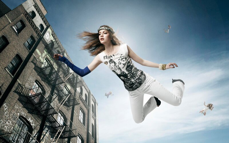 woman floating in urban sky
