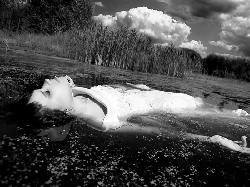 Woman Floating in Water — Black, Dramatic, Afternoon