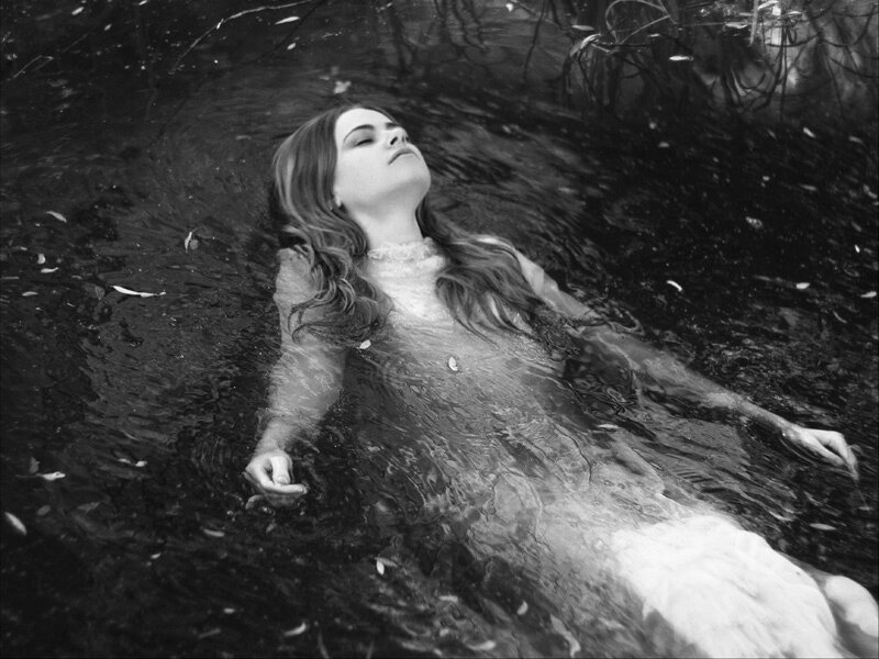 Woman Floating in Water — Black, Serene, Photograph