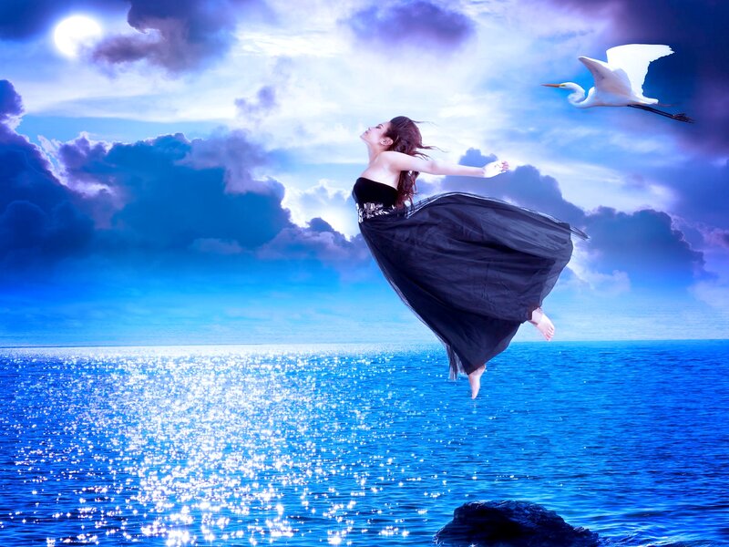 Woman Floating over Ocean