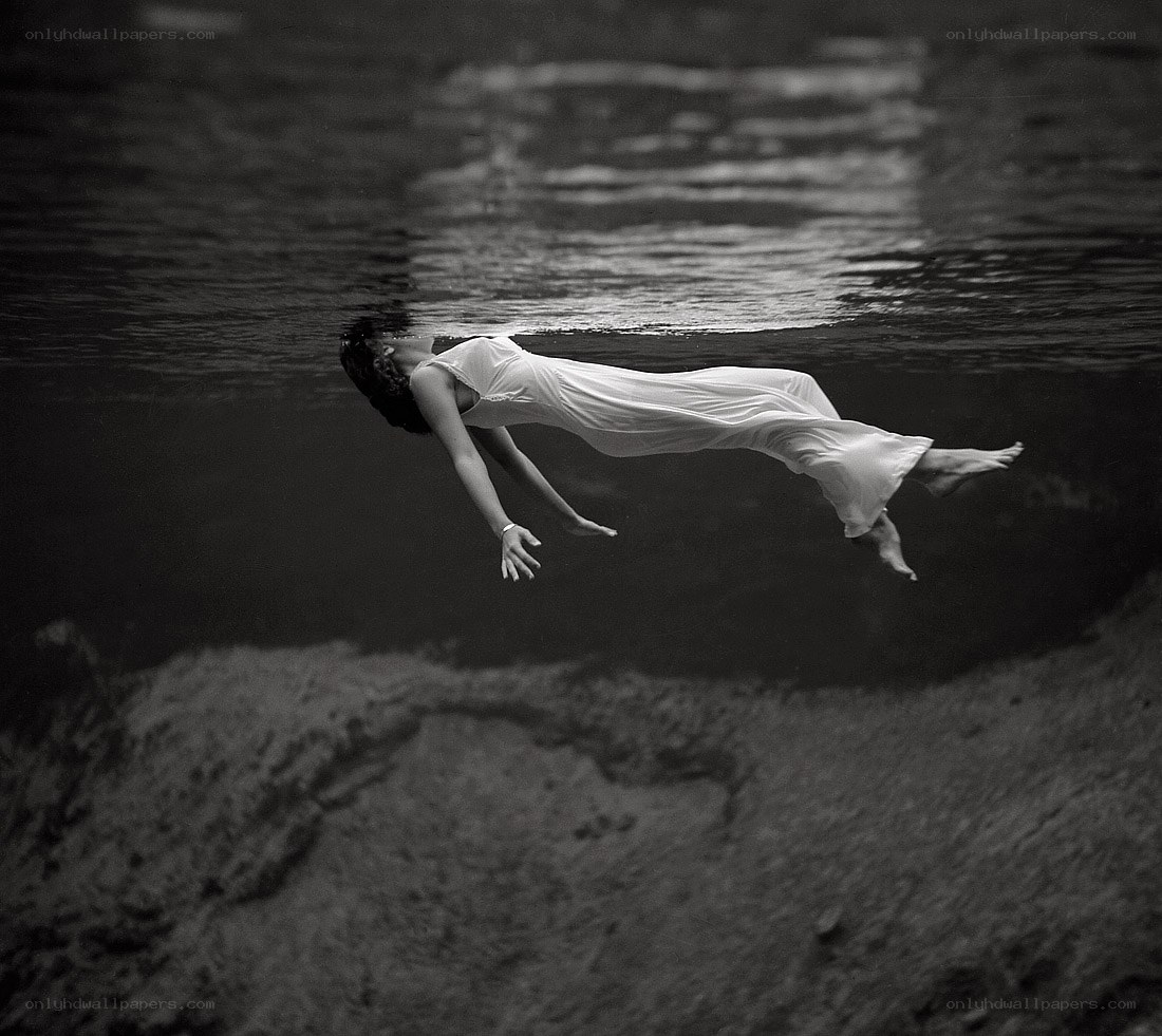 woman floating underwater