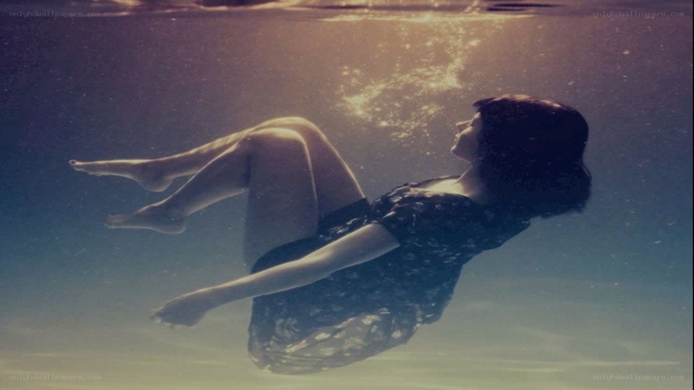 woman floating underwater