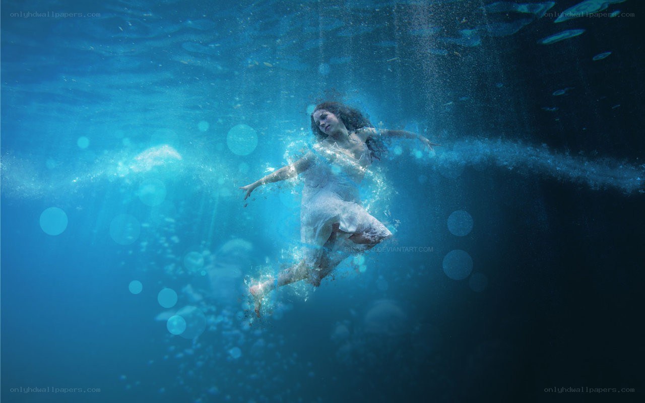 woman floating underwater