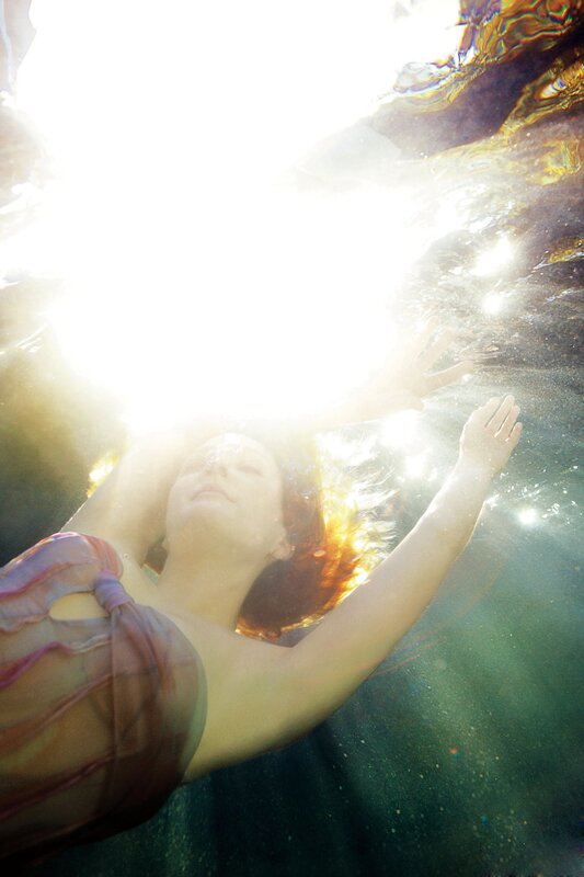 woman floating underwater