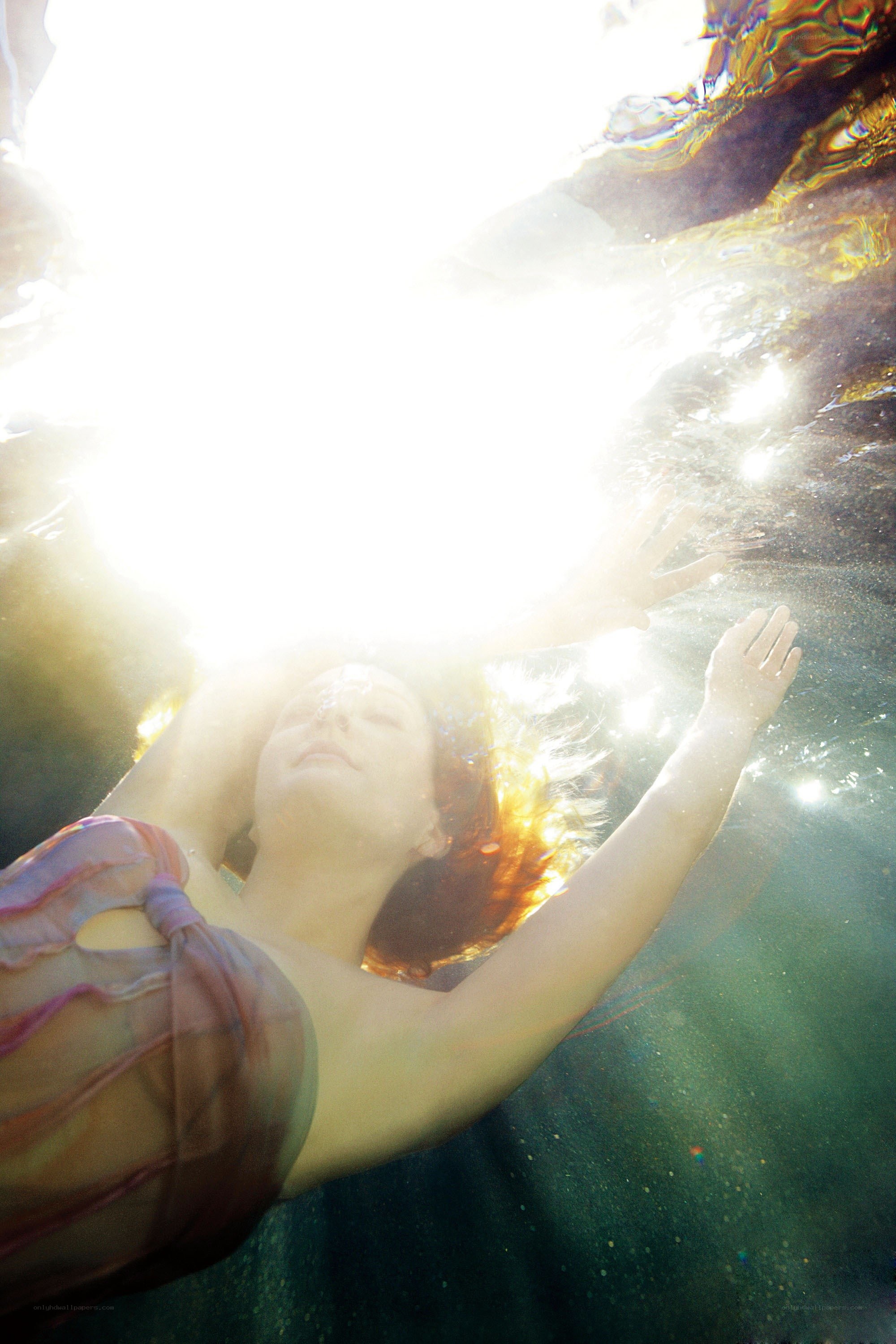 woman floating underwater