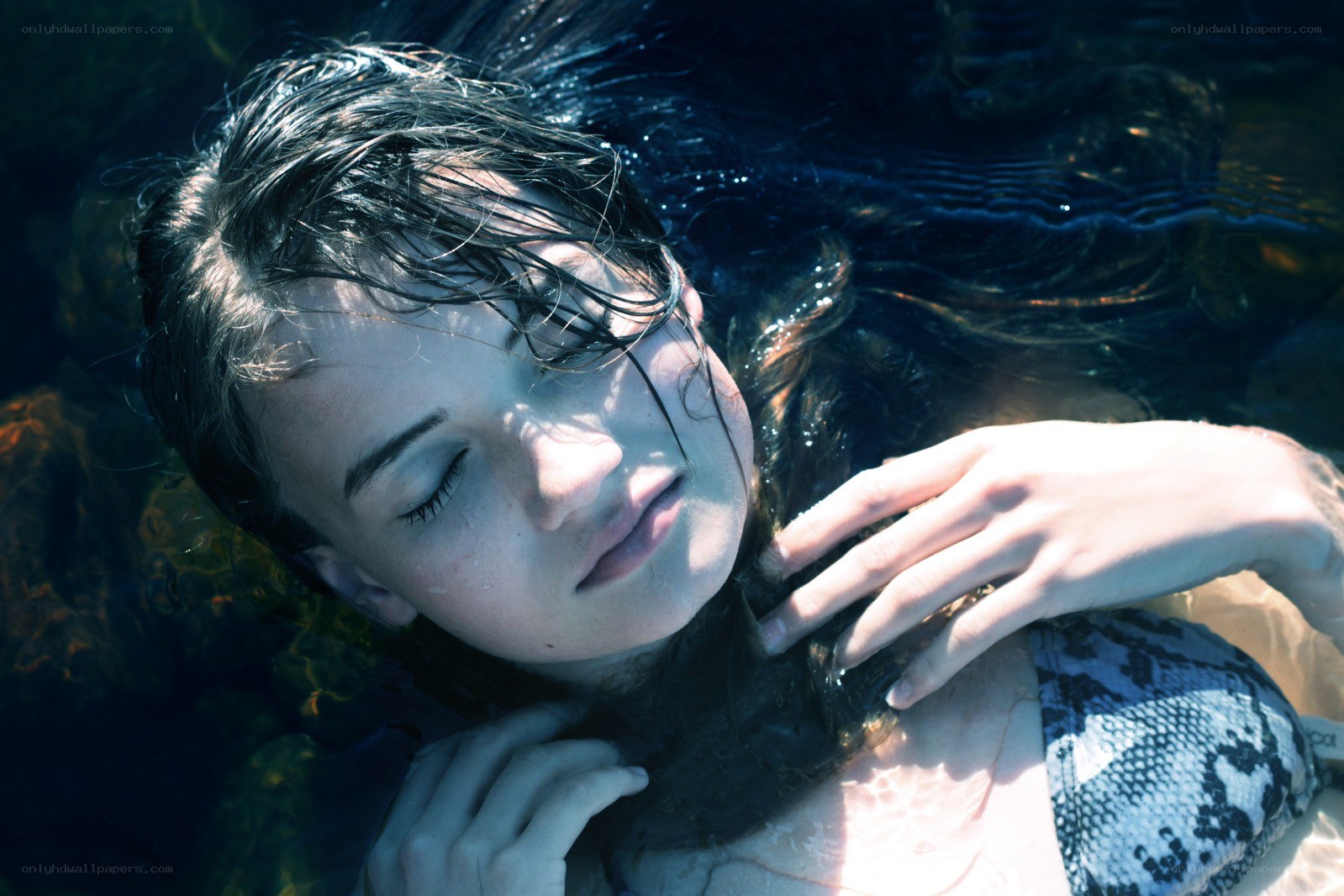 woman floating underwater