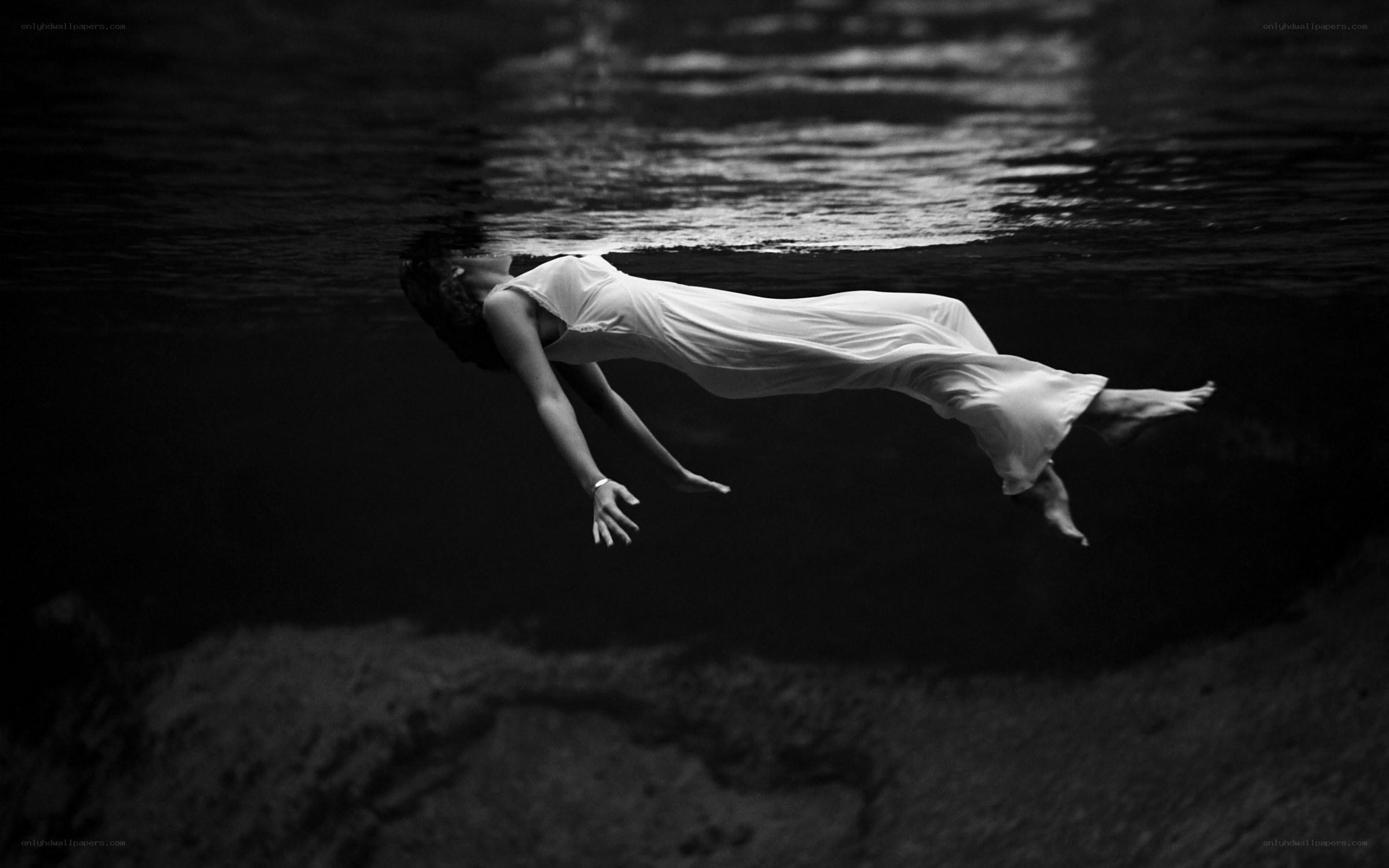 woman floating underwater