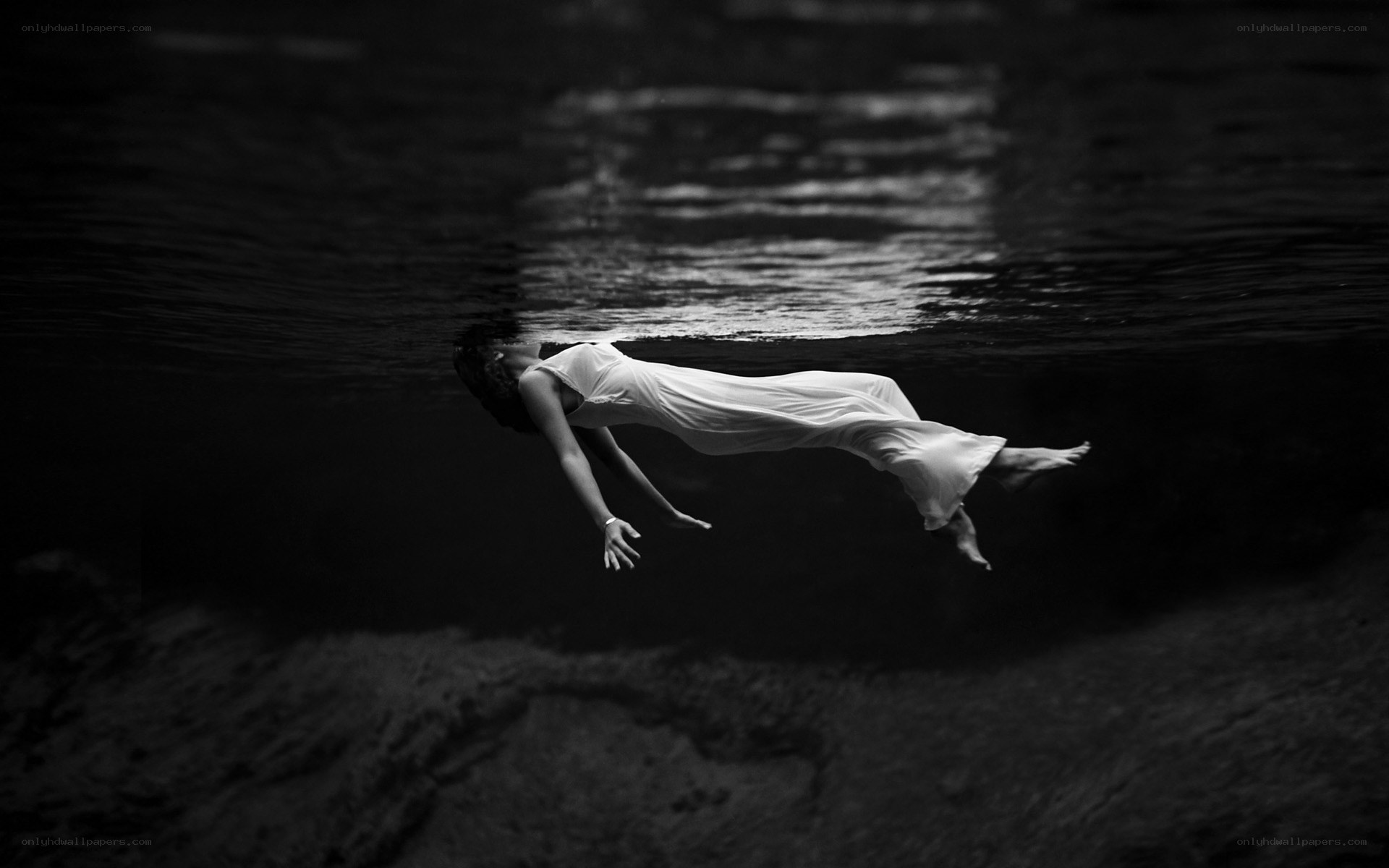 woman floating underwater