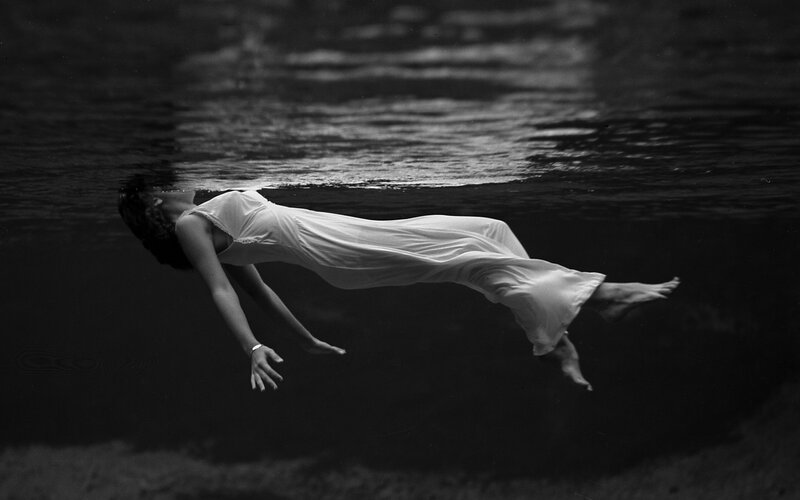 Woman Floating Underwater — Black, Serene, Photograph, Dress, Water, Surface, White, Gray