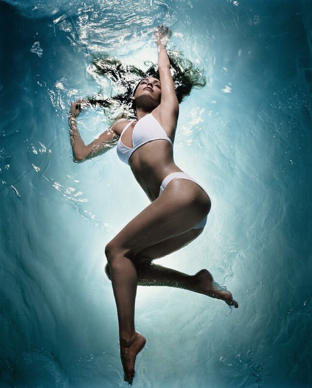 woman floating underwater in bikini