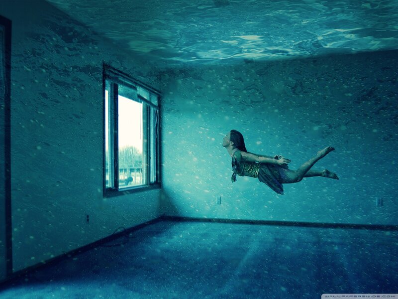 woman floating underwater in room
