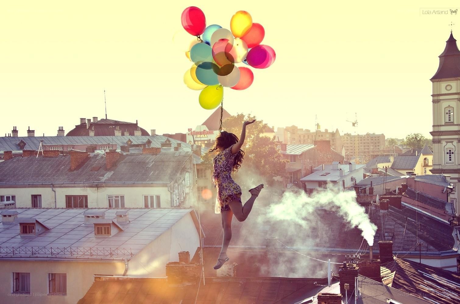 woman floating with balloons