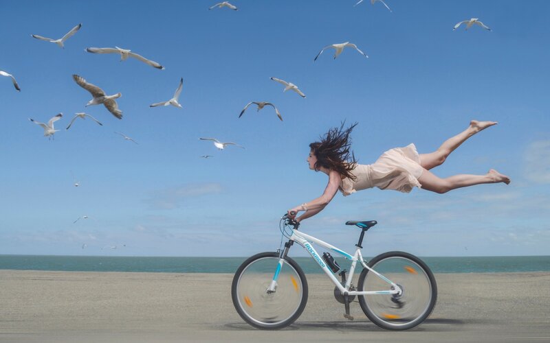 Woman Flying over Bicycle