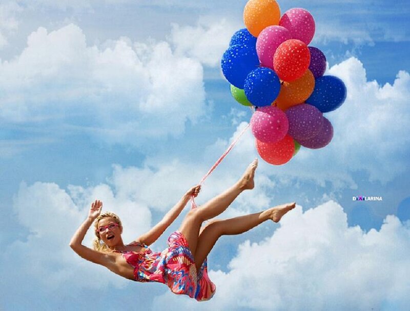 woman flying with balloons