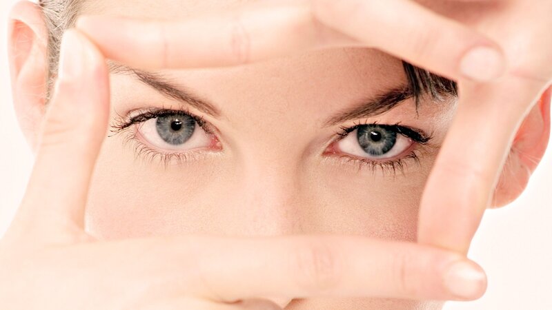 woman framing her eyes with hands