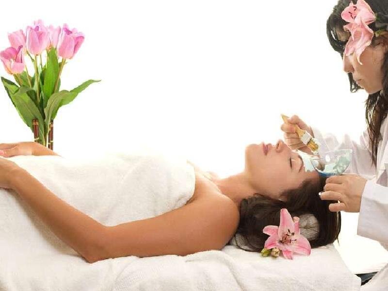 Woman getting facial treatment