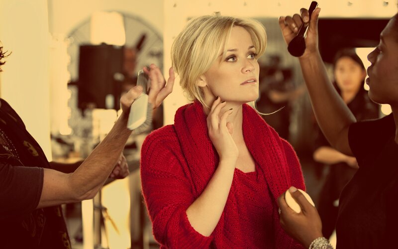 woman getting makeup and hair done