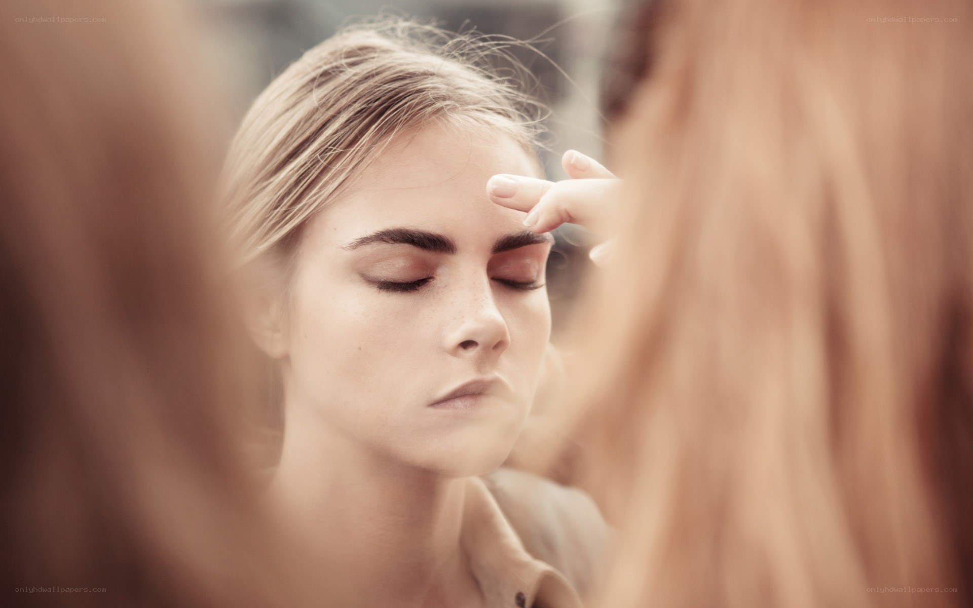woman getting makeup applied