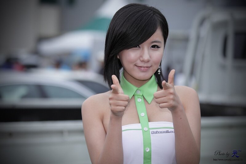 woman giving thumbs up at event