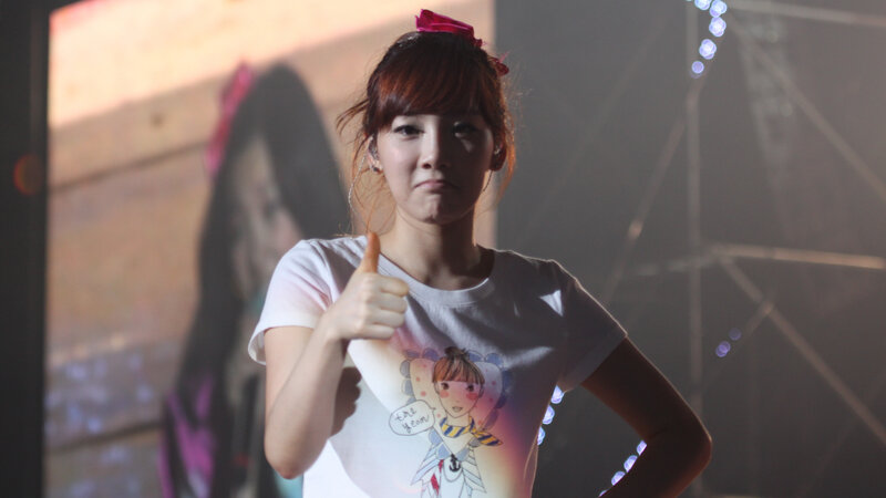 woman giving thumbs up on stage