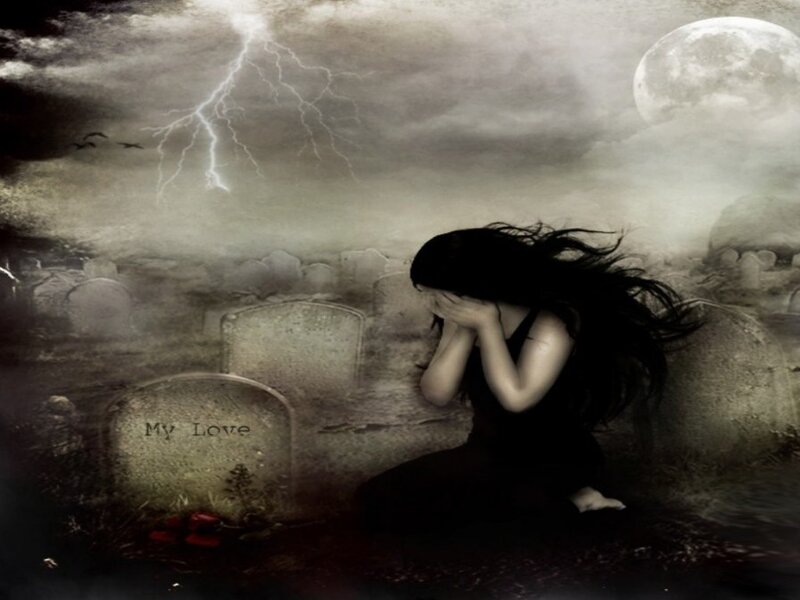 Woman grieving in a graveyard